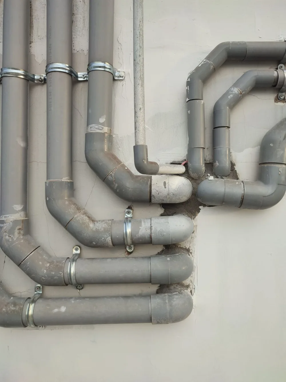 Electrical conduit pipes routed along a wall before wiring